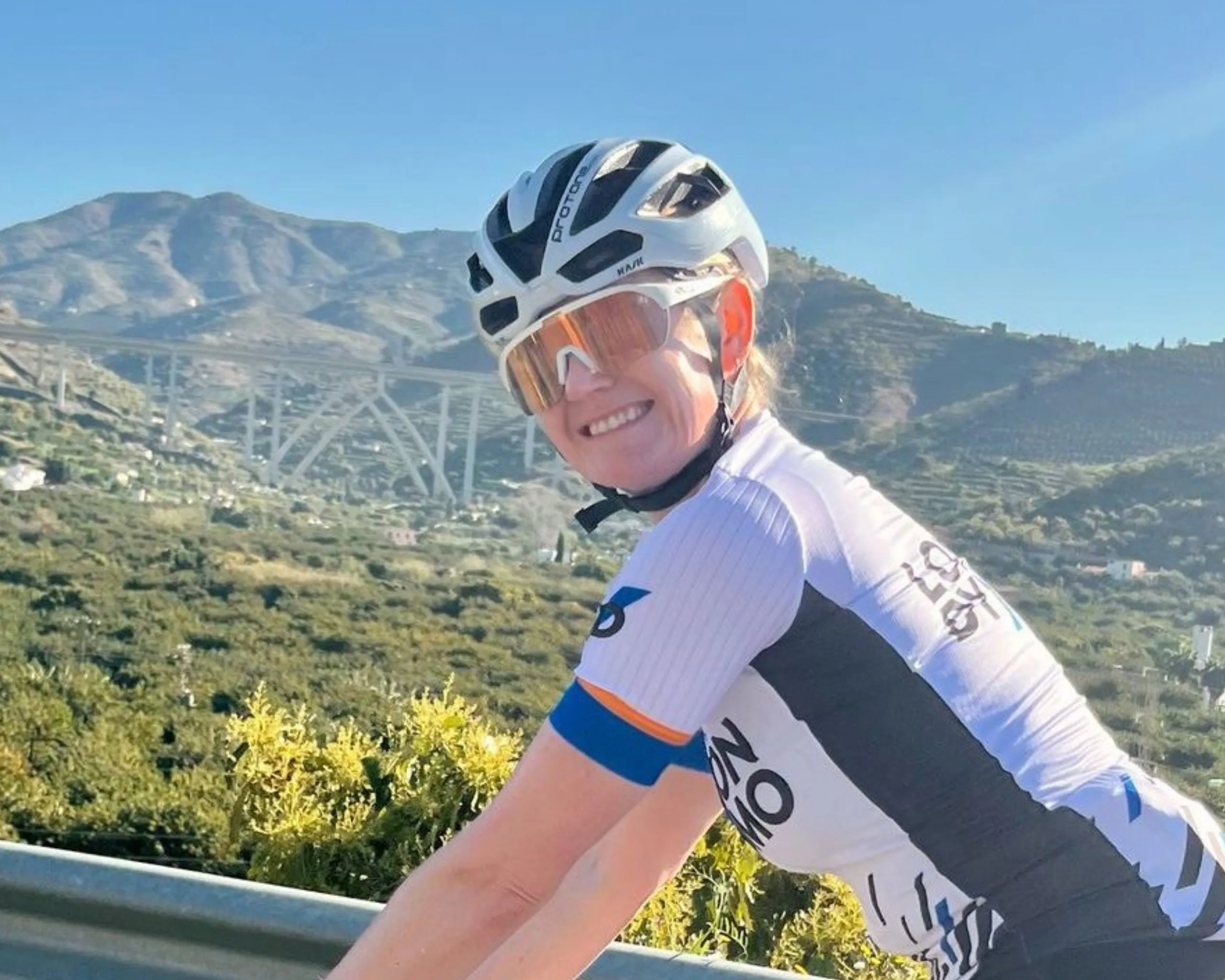 London Dynamo Kirsty Wheeler smiling at the camera riding her bike at the womens training camp in Spain