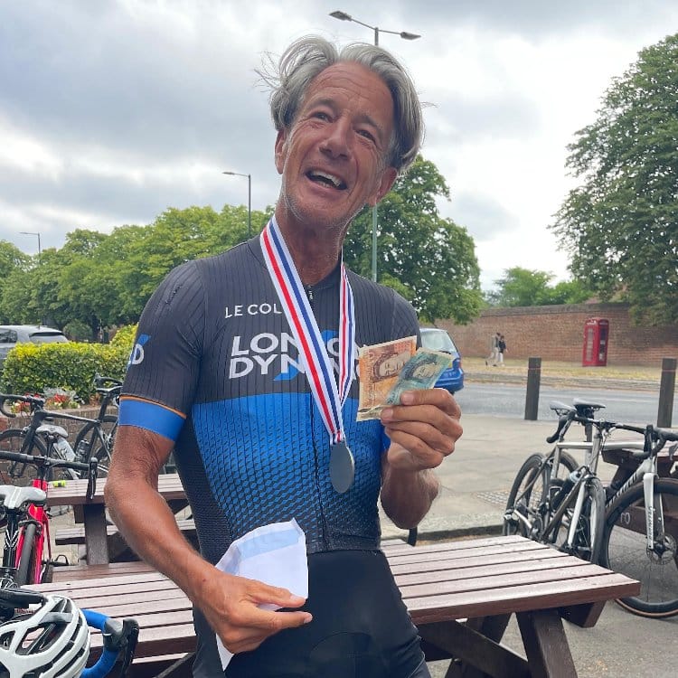 Ken Knight smiling in London Dynamo kit, holding his medal and prize
